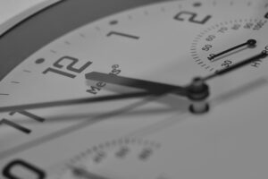 Detailed close-up of an analog clock face showing numbers and clock hands.